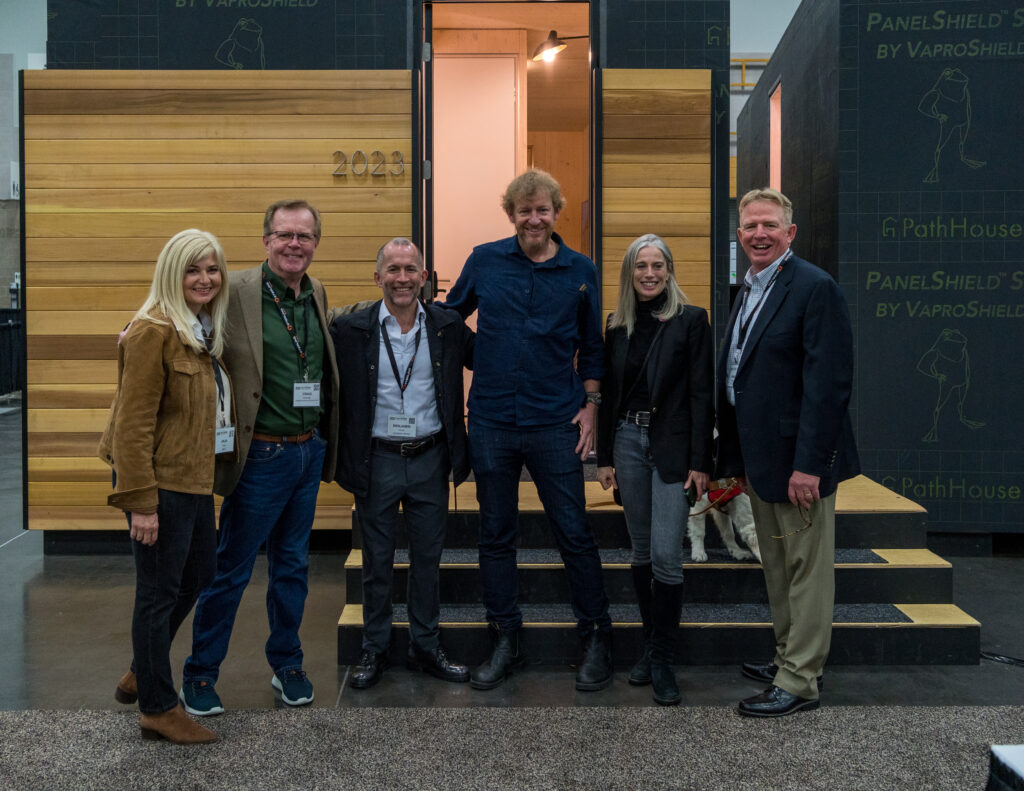 16. BEN KAISER HOSTING AN ILLUSTRIOUS GROUP OF VISITORS TO THE PATH HOUSE DISPLAY ON THE SHOW FLOOR